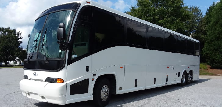 a plain white ETI Coach Bus charter bus